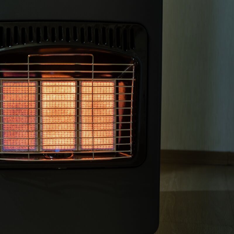 Close-up of glowing heating elements inside a unit requiring professional gas heater repairs.